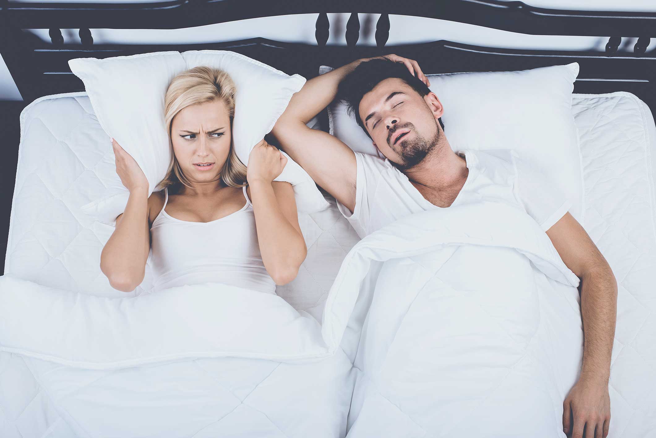 Woman struggling to sleep because of her husband's sleep apnea