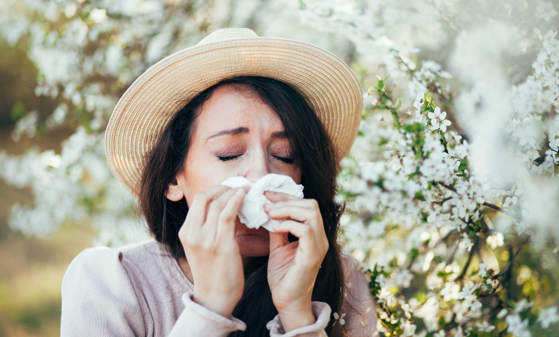 Woman blowing her nose