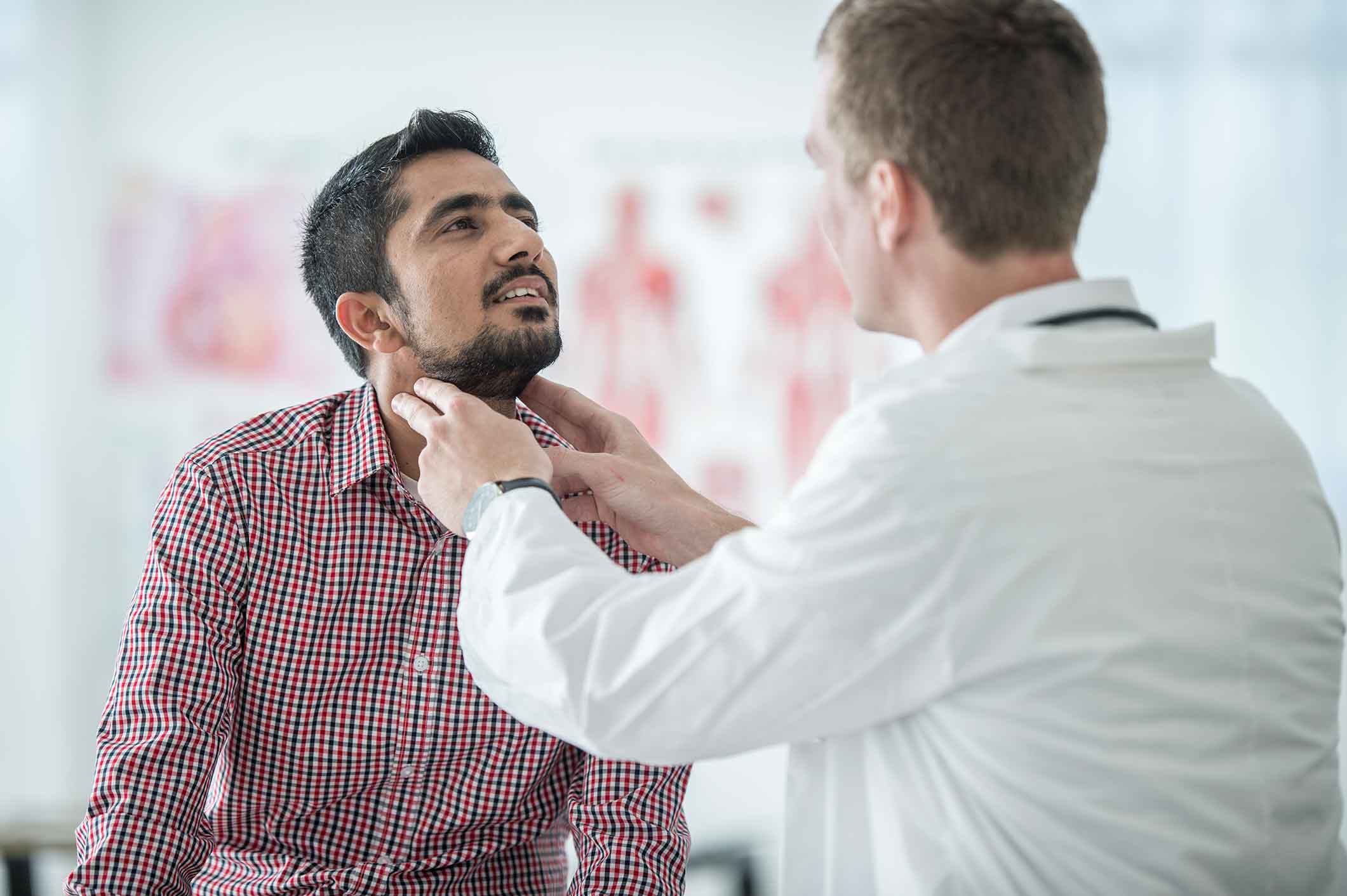 Doctor examining a patient's throat