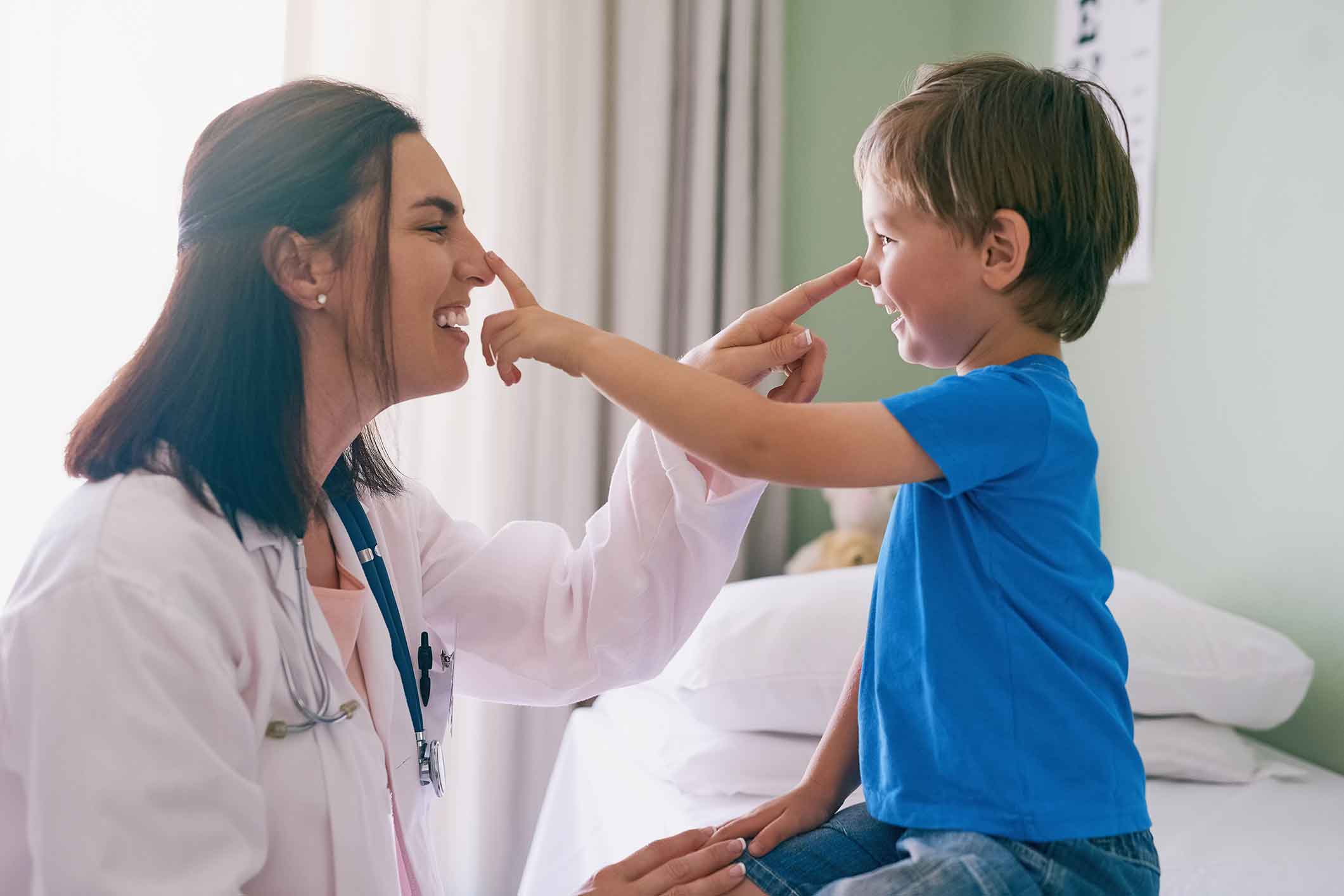Doctor playing around a with a young patient