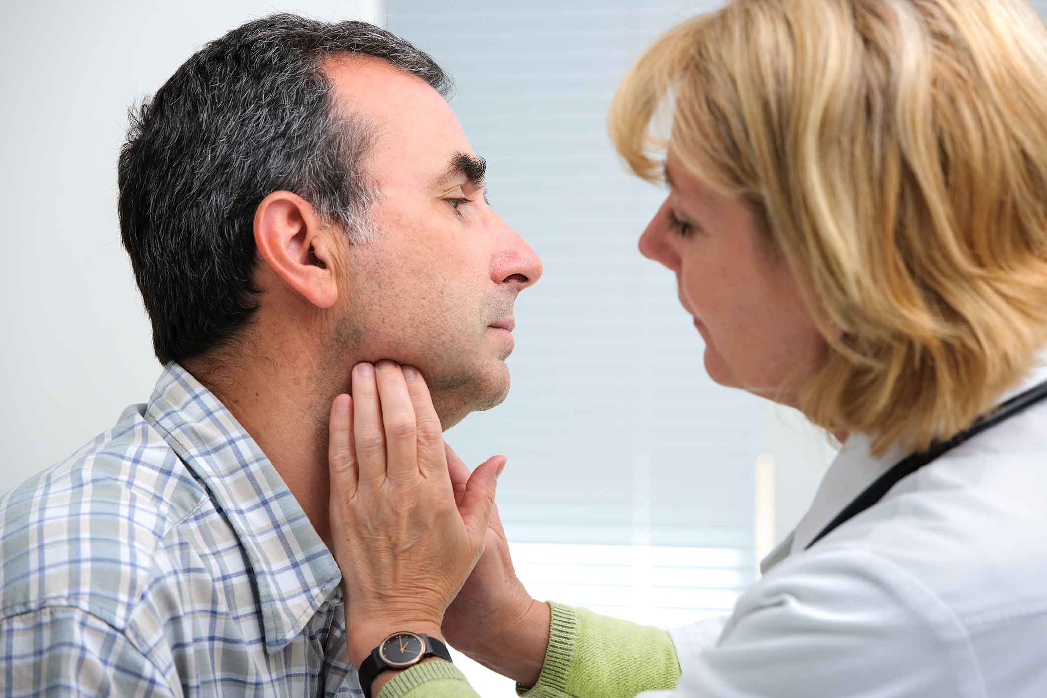 Doctor examining a patient's throat